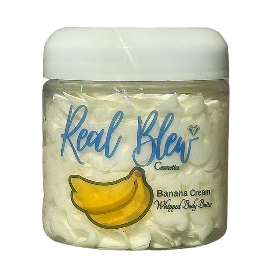4oz Banana Creamy Whipped Body Butter Skincare Moisturizer with a white lid, yellow bananas on front and Real Blew Cosmetics in fancy writing; internal contents (body butter) is cream colored
